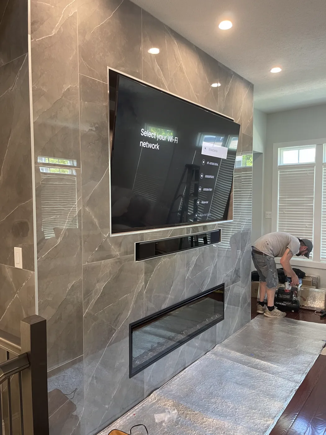 After — Steel-stud framing to a finished porcelain fireplace feature wall