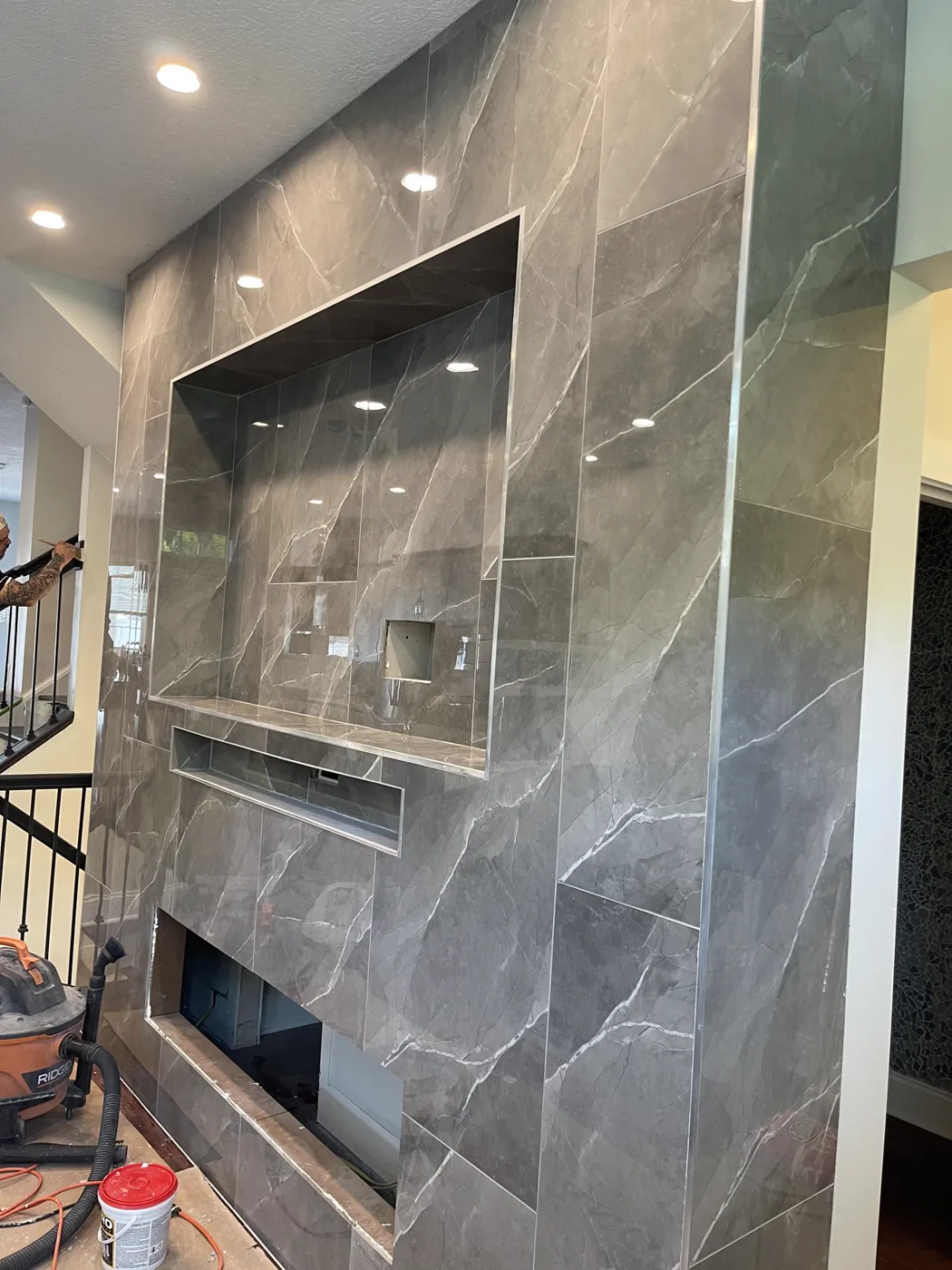 Floor-to-ceiling porcelain tile & lit niches
