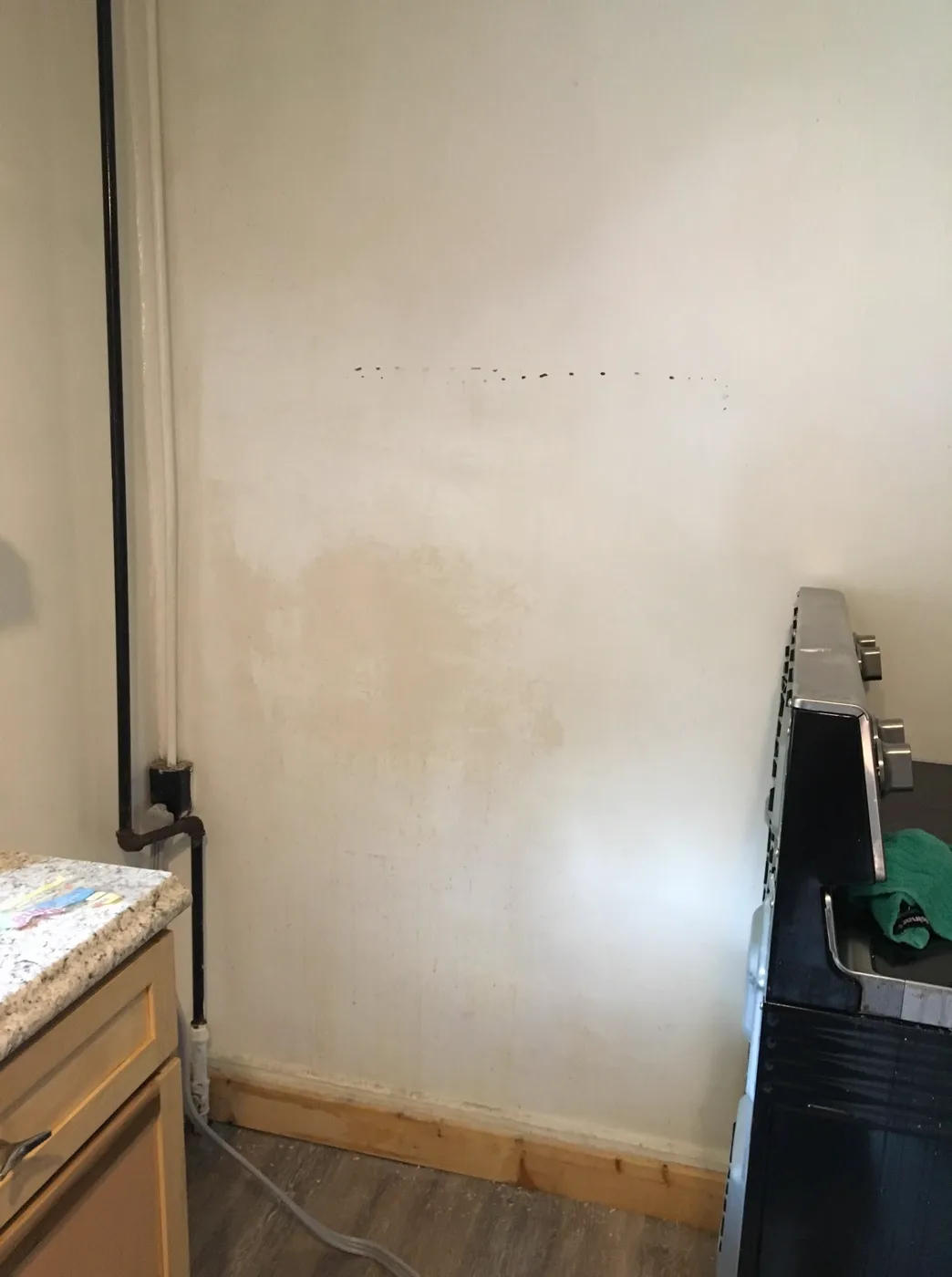 Before — Bare kitchen wall to a fresh terracotta tile backsplash